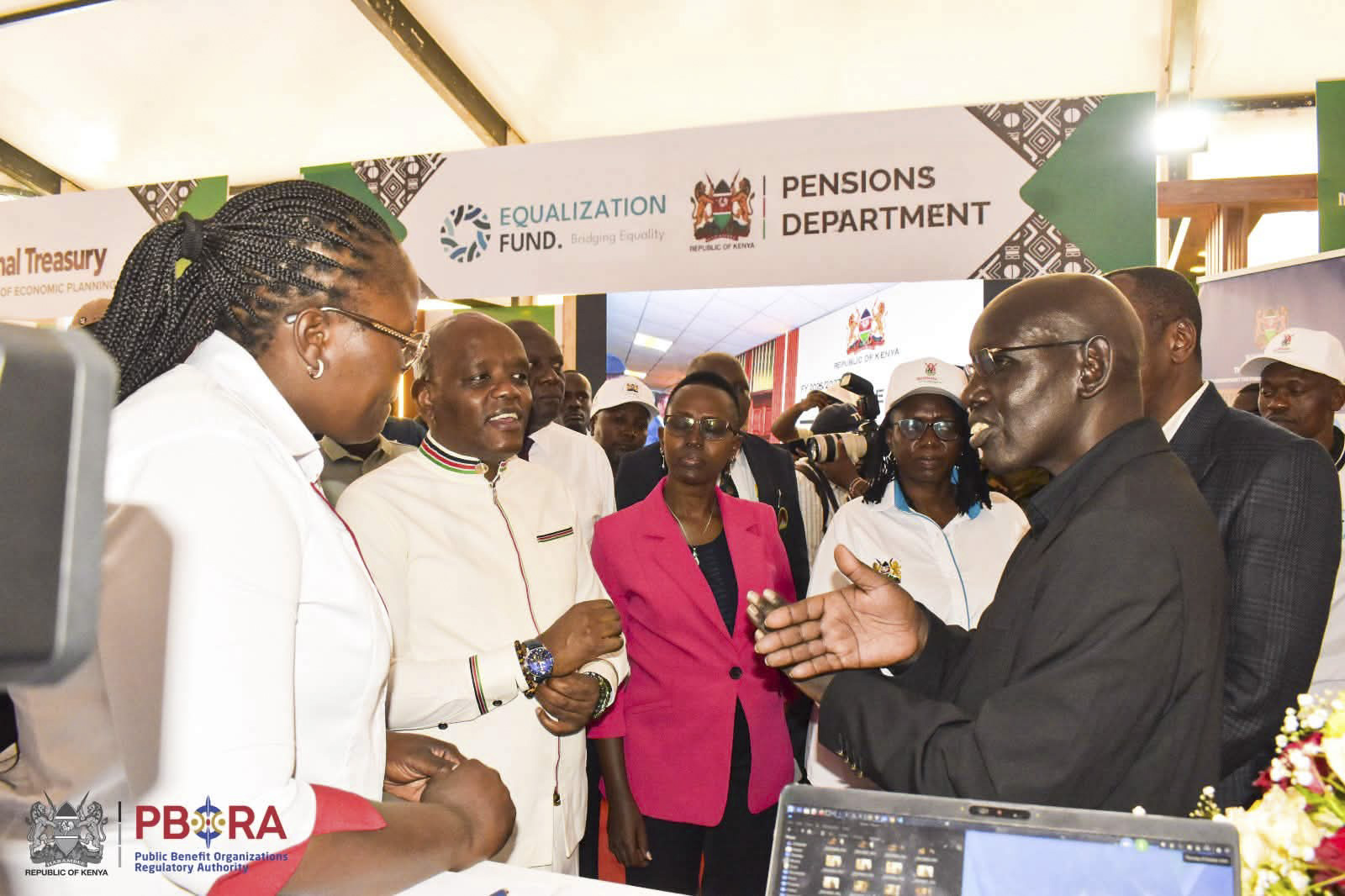 PS Immigration Dr. Belio Kipsang interacts with PBORA officers at the Authority's booth at Eldoret National Polytechnic during Mashujaa Thematic exhibition. 