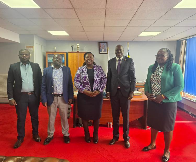 Dr. Laxmana Kiptoo poses for a photo with TI-Kenya Executive Director Sheila Masinde (on his right) at his office in Nairobi.